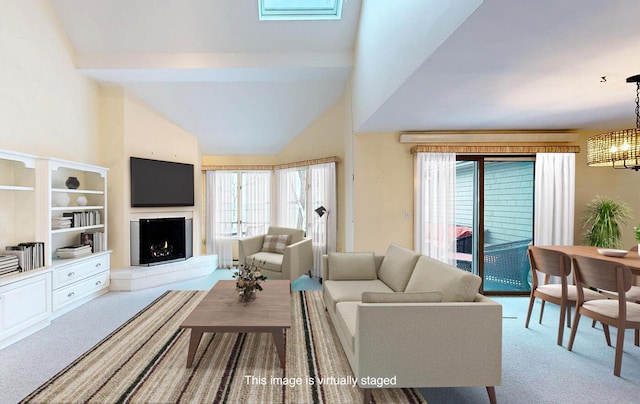 9 Jameson Point Rd Unit 10, Rockland, ME 04841 - carpeted living room with a chandelier, high vaulted ceiling, and a lit fireplace