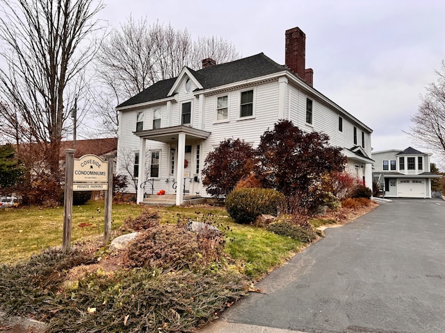 view of front of home with a garage and a front lawn