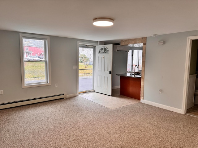 foyer entrance with a wall mounted AC, light colored carpet, and a baseboard heating unit