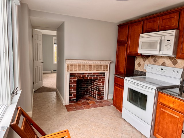 kitchen featuring backsplash, a fireplace, and white appliances