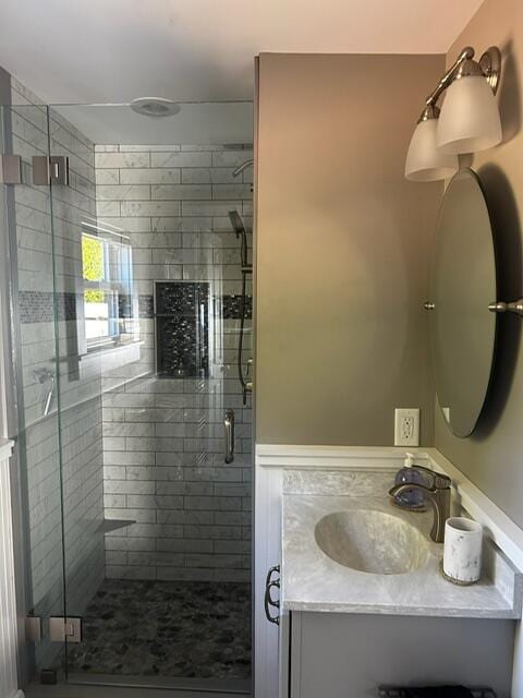 bathroom with vanity and a shower with shower door