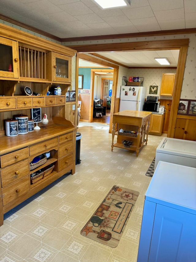 kitchen with ornamental molding and white fridge