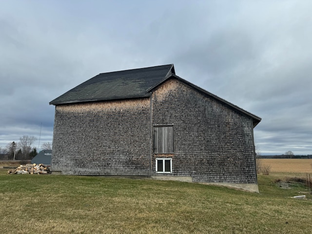 view of side of home with a lawn