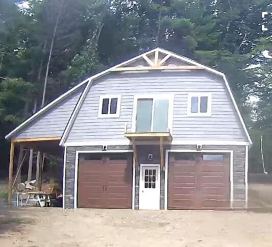 47 Fickett Dr, Litchfield, ME 04350 - view of front of property with a gambrel roof and an attached garage