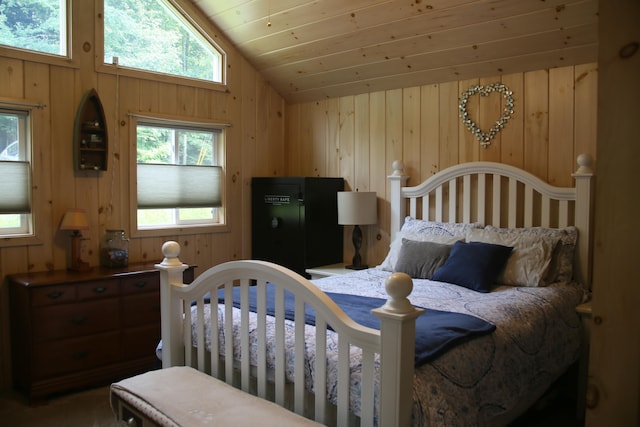 bedroom featuring multiple windows, wooden walls, wood ceiling, and vaulted ceiling