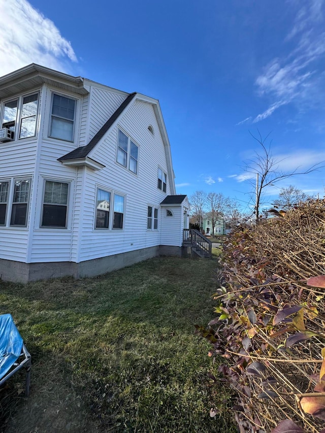 view of side of home featuring a yard