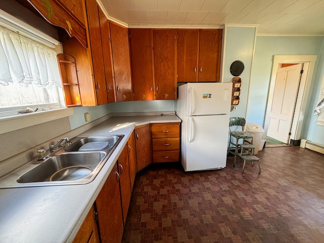 kitchen with dark hardwood / wood-style flooring, sink, ornamental molding, and white refrigerator