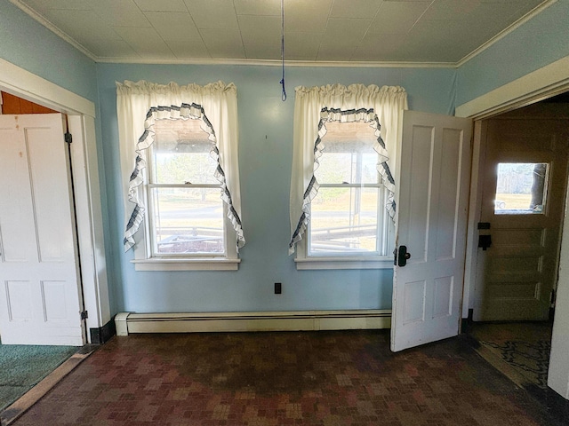 interior space featuring baseboard heating, a wealth of natural light, crown molding, and dark colored carpet