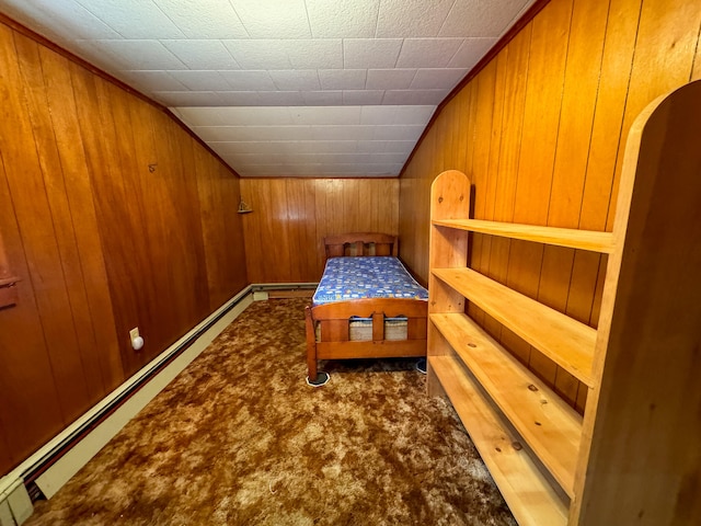 bedroom with carpet, lofted ceiling, a baseboard heating unit, and wood walls