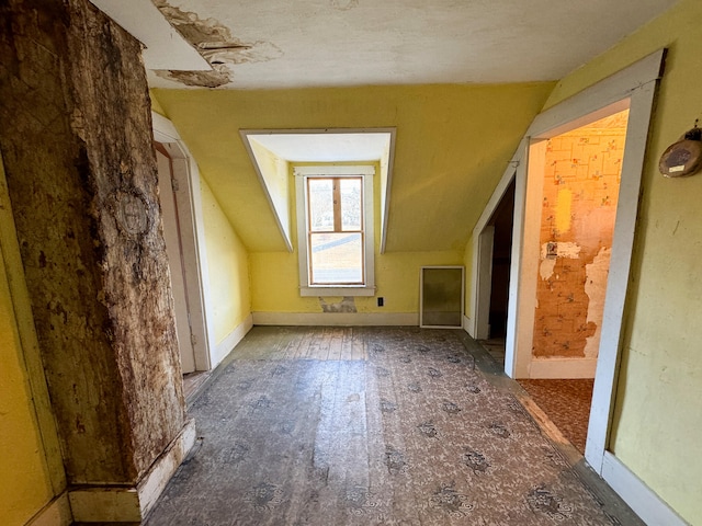 additional living space featuring lofted ceiling