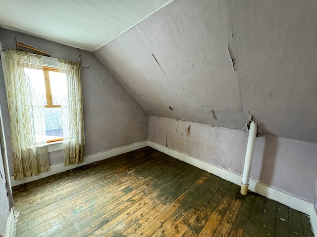 bonus room with lofted ceiling and dark wood-type flooring