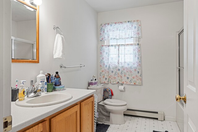 full bathroom featuring vanity, a baseboard radiator, toilet, and bath / shower combo with glass door