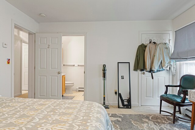 carpeted bedroom featuring baseboard heating