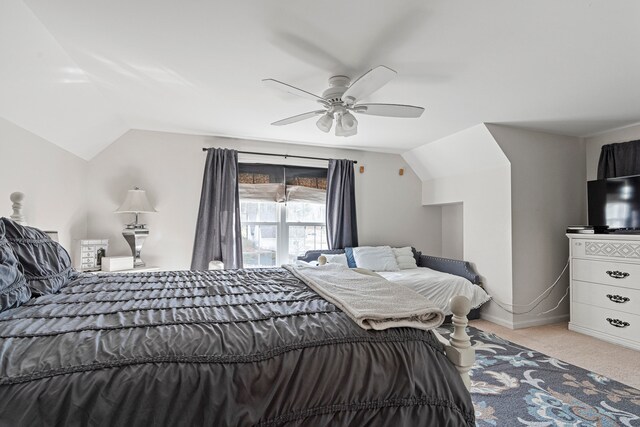 carpeted bedroom featuring ceiling fan and vaulted ceiling