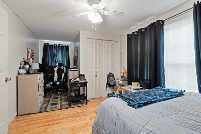 bedroom featuring ceiling fan, a closet, and hardwood / wood-style flooring