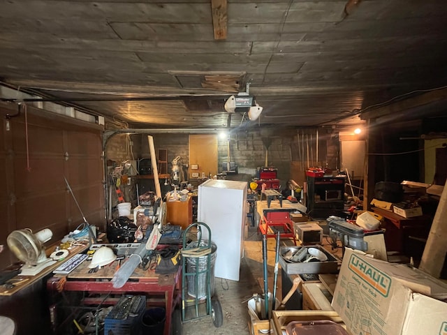 garage featuring a garage door opener and a workshop area