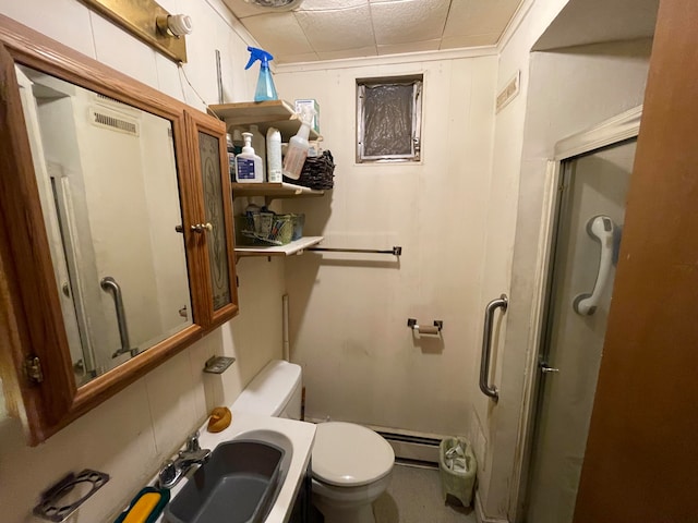 bathroom featuring walk in shower, sink, toilet, and baseboard heating