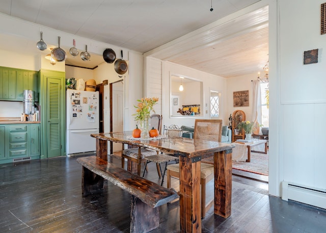 dining room with dark hardwood / wood-style flooring and a baseboard radiator