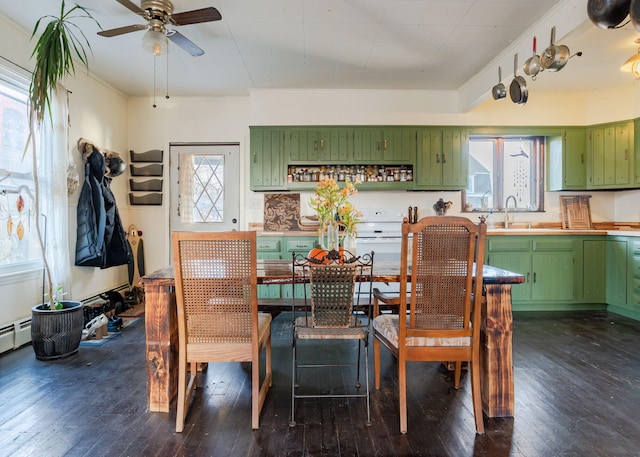 dining room with dark hardwood / wood-style floors, ceiling fan, ornamental molding, and sink