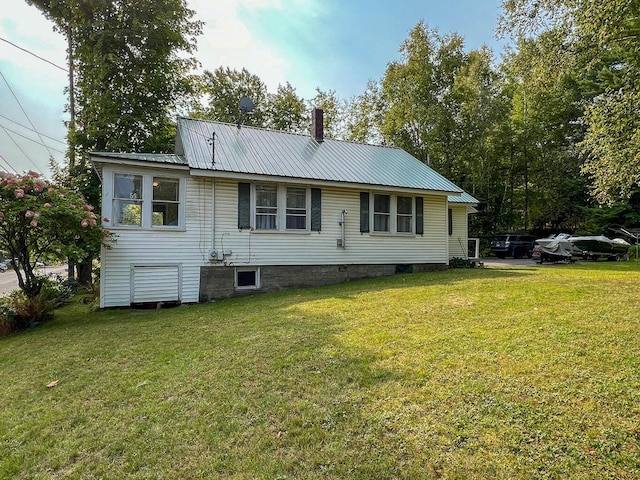 rear view of property featuring a lawn