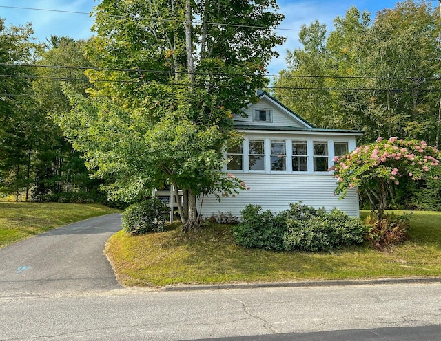 view of side of home with a lawn