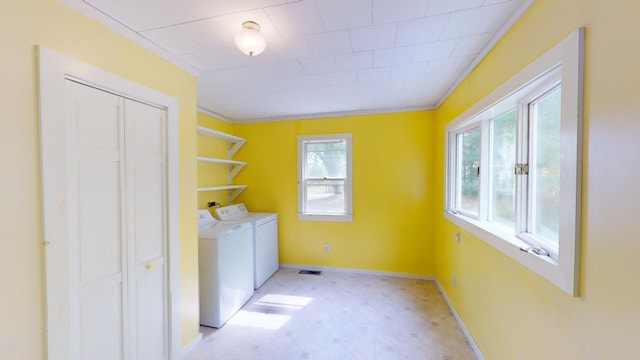 washroom with independent washer and dryer and crown molding