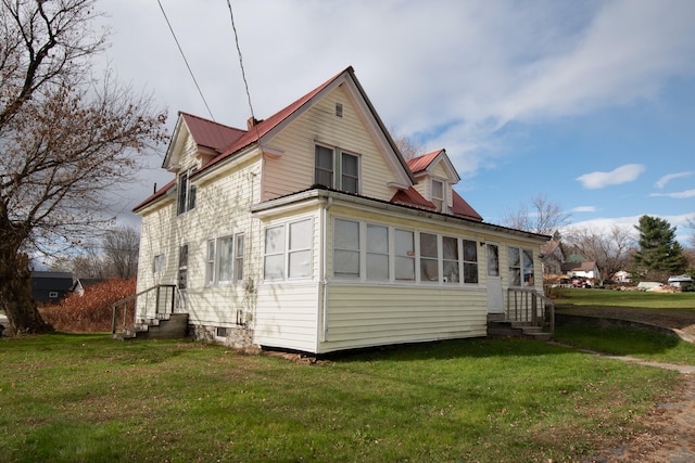 back of property with a lawn