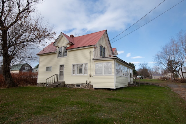 rear view of property with a lawn