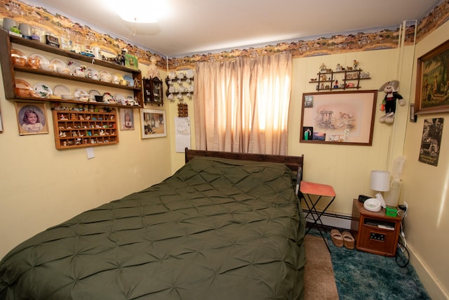 bedroom with carpet and baseboard heating