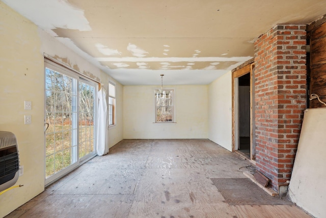 454 N Parish Rd, Turner, ME 04282 - unfurnished dining area featuring a notable chandelier, decorative columns, and heating unit