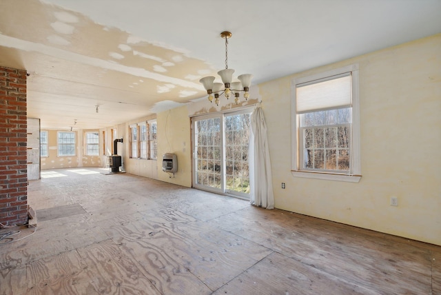 454 N Parish Rd, Turner, ME 04282 - interior space featuring heating unit, a wood stove, and an inviting chandelier