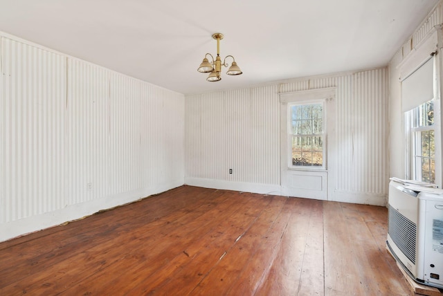 454 N Parish Rd, Turner, ME 04282 - spare room featuring heating unit, hardwood / wood-style flooring, and a notable chandelier