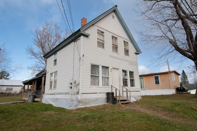 back of house with a yard