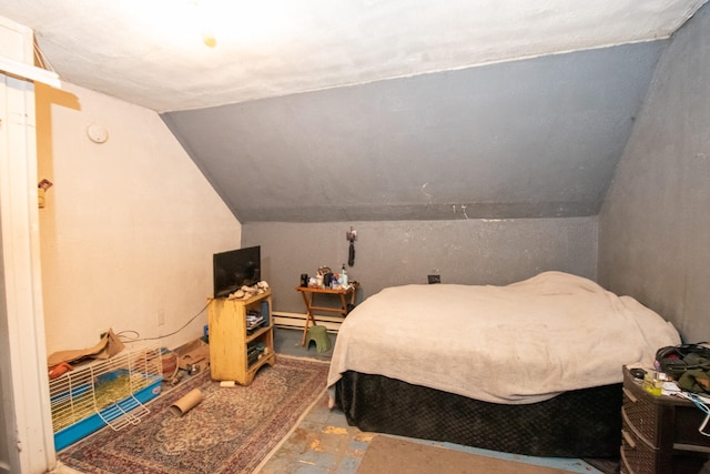 bedroom with lofted ceiling and a baseboard heating unit