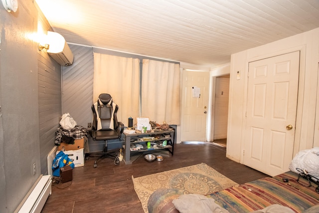 interior space with dark hardwood / wood-style flooring, an AC wall unit, and a baseboard heating unit