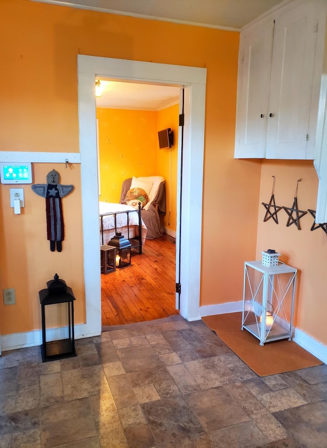 599 Plains Rd, Hollis, ME 04042 - hall featuring dark stone finish floors and baseboards