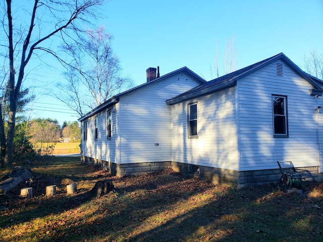 599 Plains Rd, Hollis, ME 04042 - view of side of home with a chimney
