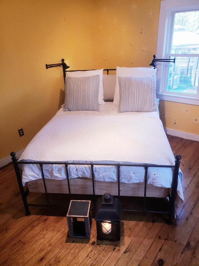 599 Plains Rd, Hollis, ME 04042 - bedroom with hardwood / wood-style flooring and baseboards