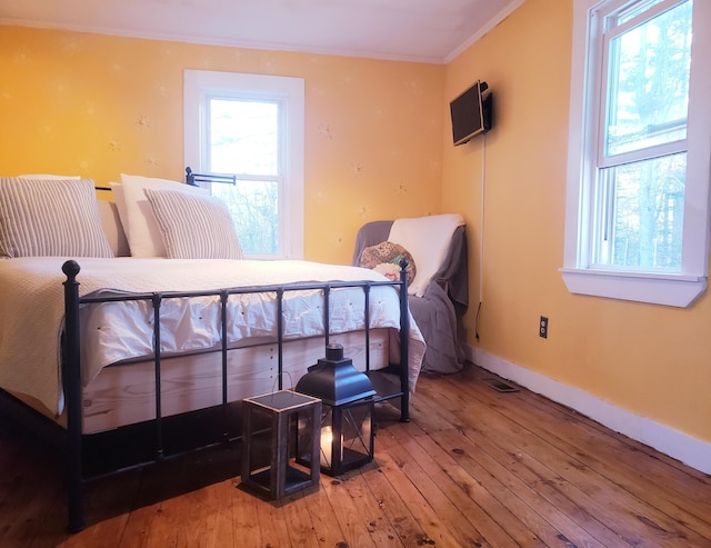 599 Plains Rd, Hollis, ME 04042 - bedroom featuring hardwood / wood-style floors, crown molding, and baseboards