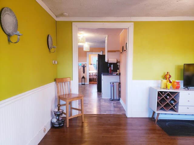 599 Plains Rd, Hollis, ME 04042 - corridor featuring a textured ceiling, wainscoting, and wood finished floors