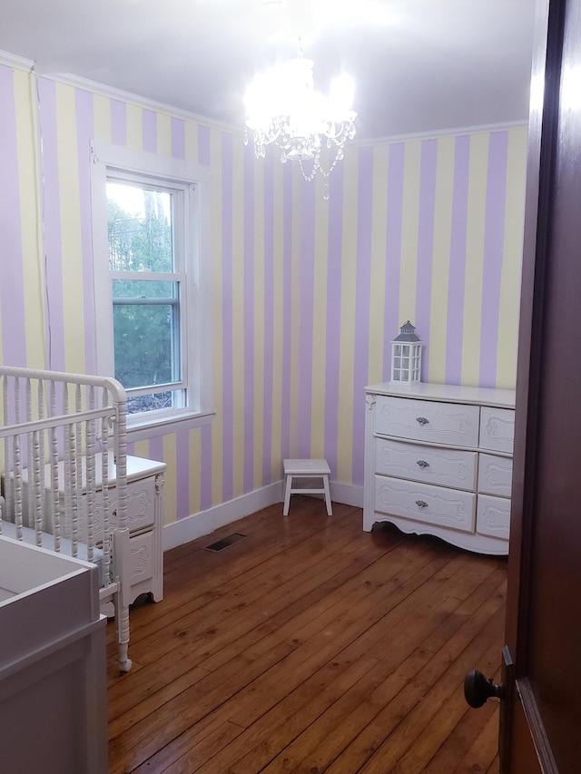 599 Plains Rd, Hollis, ME 04042 - bedroom with dark wood-type flooring, a chandelier, and baseboards