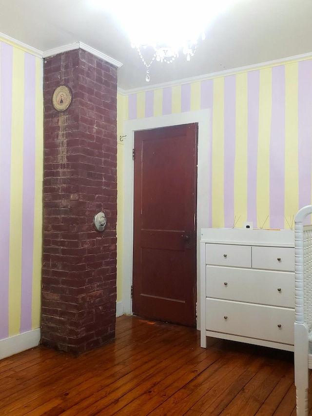 599 Plains Rd, Hollis, ME 04042 - bedroom featuring dark wood-style floors, wallpapered walls, ornamental molding, and baseboards
