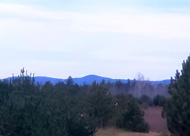599 Plains Rd, Hollis, ME 04042 - view of mountain backdrop with a forest