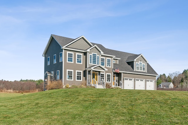 view of front of property featuring a front lawn and a garage