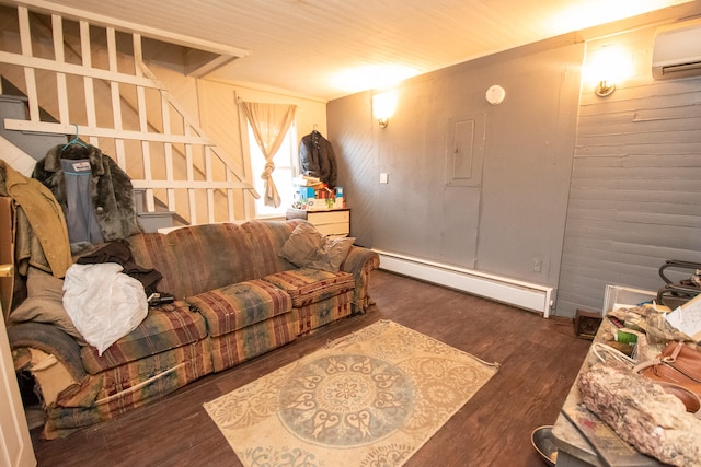 living room featuring dark hardwood / wood-style floors, wood walls, a wall unit AC, and a baseboard heating unit