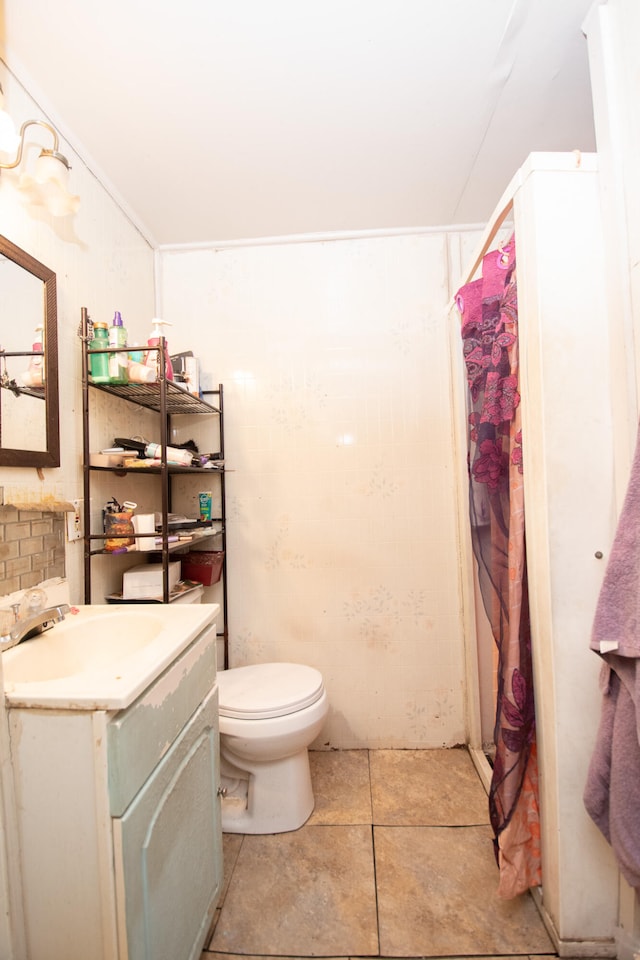 bathroom featuring tile patterned flooring, vanity, and toilet