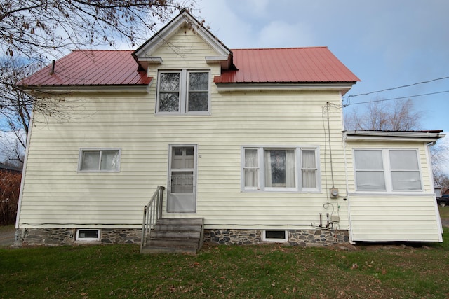 back of property featuring a yard