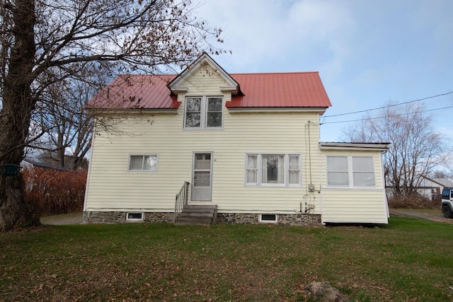 back of house with a lawn