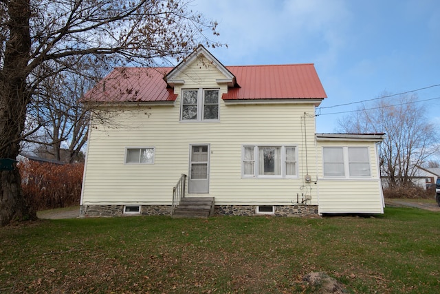 back of property with a lawn