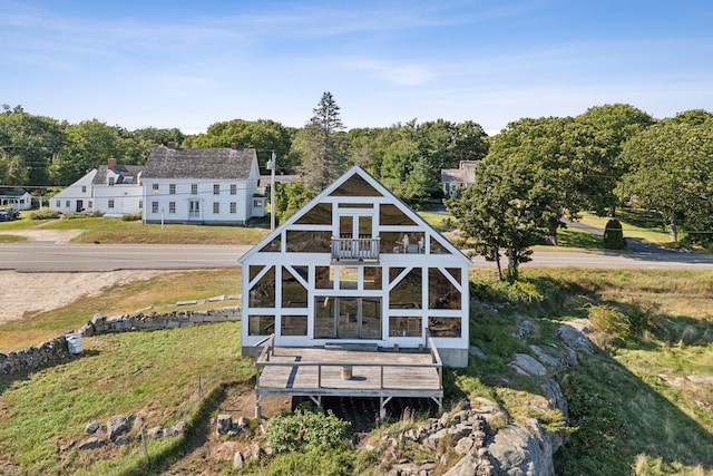 rear view of property featuring a balcony